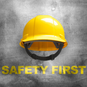 Yellow safety helmet on concrete wall background Yellow safety helmet on concrete wall background