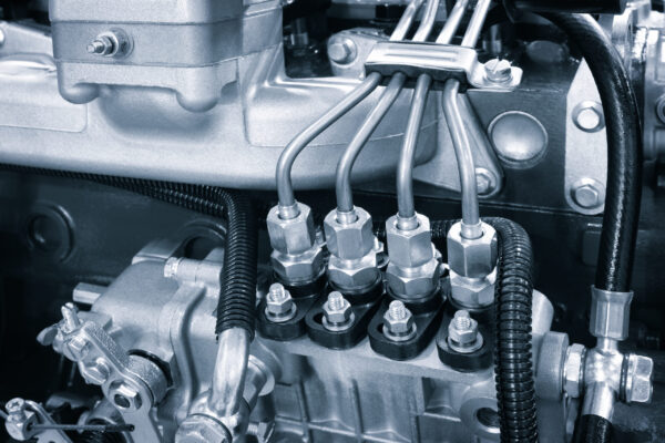 Engine details background close up. diesel engine in blue tone. Fragment of a diesel motor close-up. Selective on the fuel injection in the the diesel engine. supply system for diesel fuel. Engine details background close up. diesel engine in blue tone. Fragment of a diesel motor close-up. Selective on the fuel injection in the the diesel engine. supply system for diesel fuel.